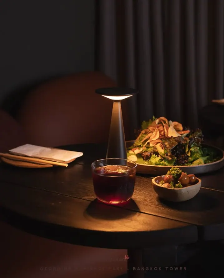 Ambiente interno do Kobi Izakaya com luz baixa, mesas e clima intimista